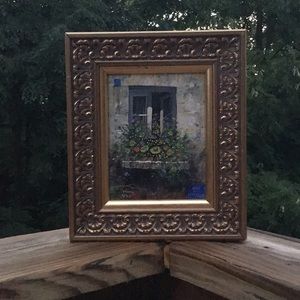 Vintage oil on board painting of a cottage with floral theme